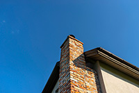 Upward angle photo of a red brick chimney - Red Bank chimney service